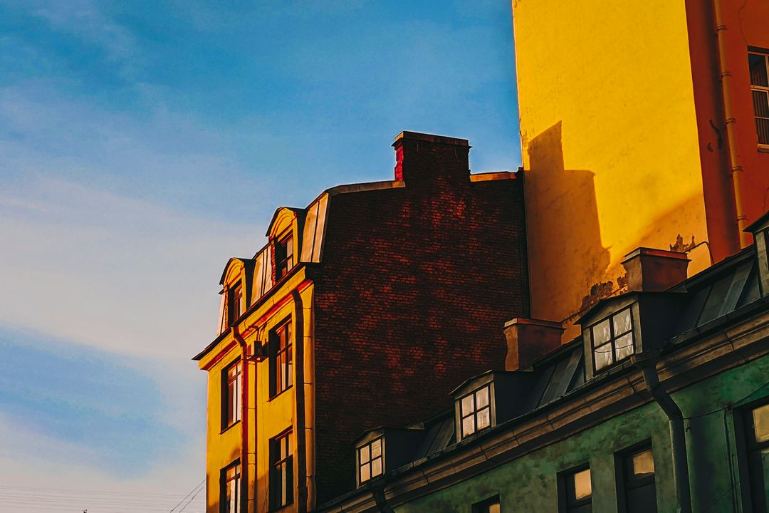 Old town houses in low evening sun against a pale sky, edited by Maren