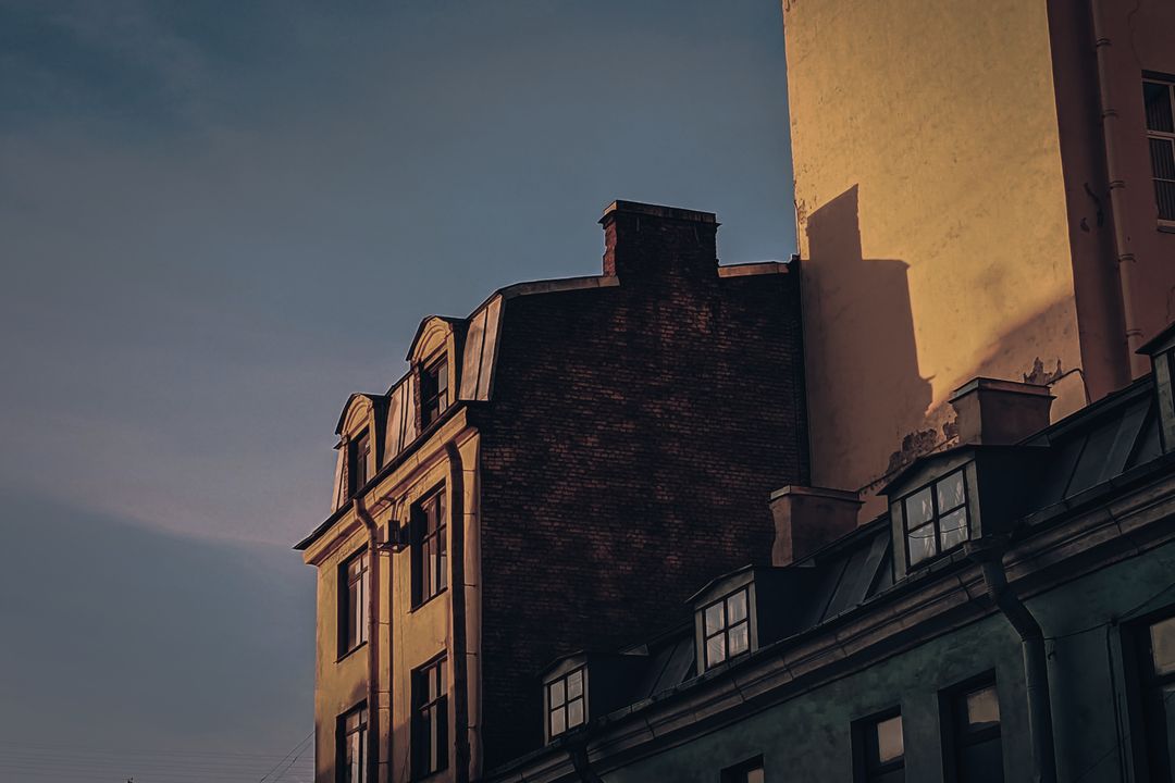 Old town houses in low evening sun against a pale sky, edited by Rafe